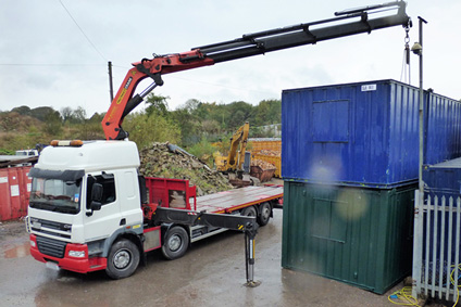 hiab crane lifting blue shipping container