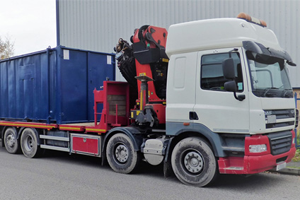 side picture of blue refurbished storage container on the hiab lorry